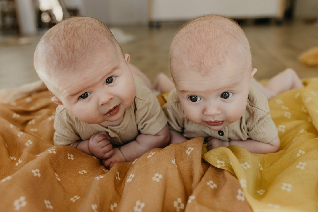 baby boys doing tummy time on a blanket
