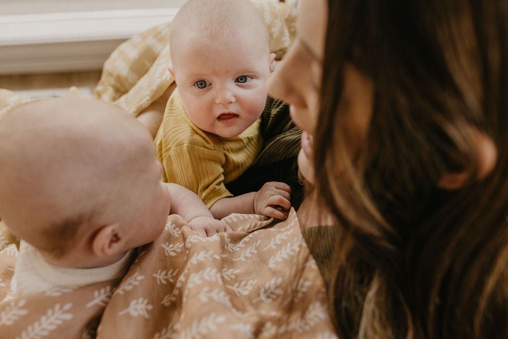 momma playing with twin baby girls