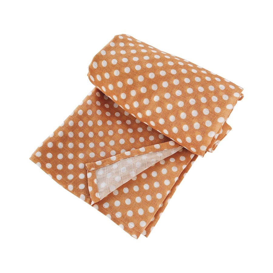 half rolled amber polka dot swaddle blanket