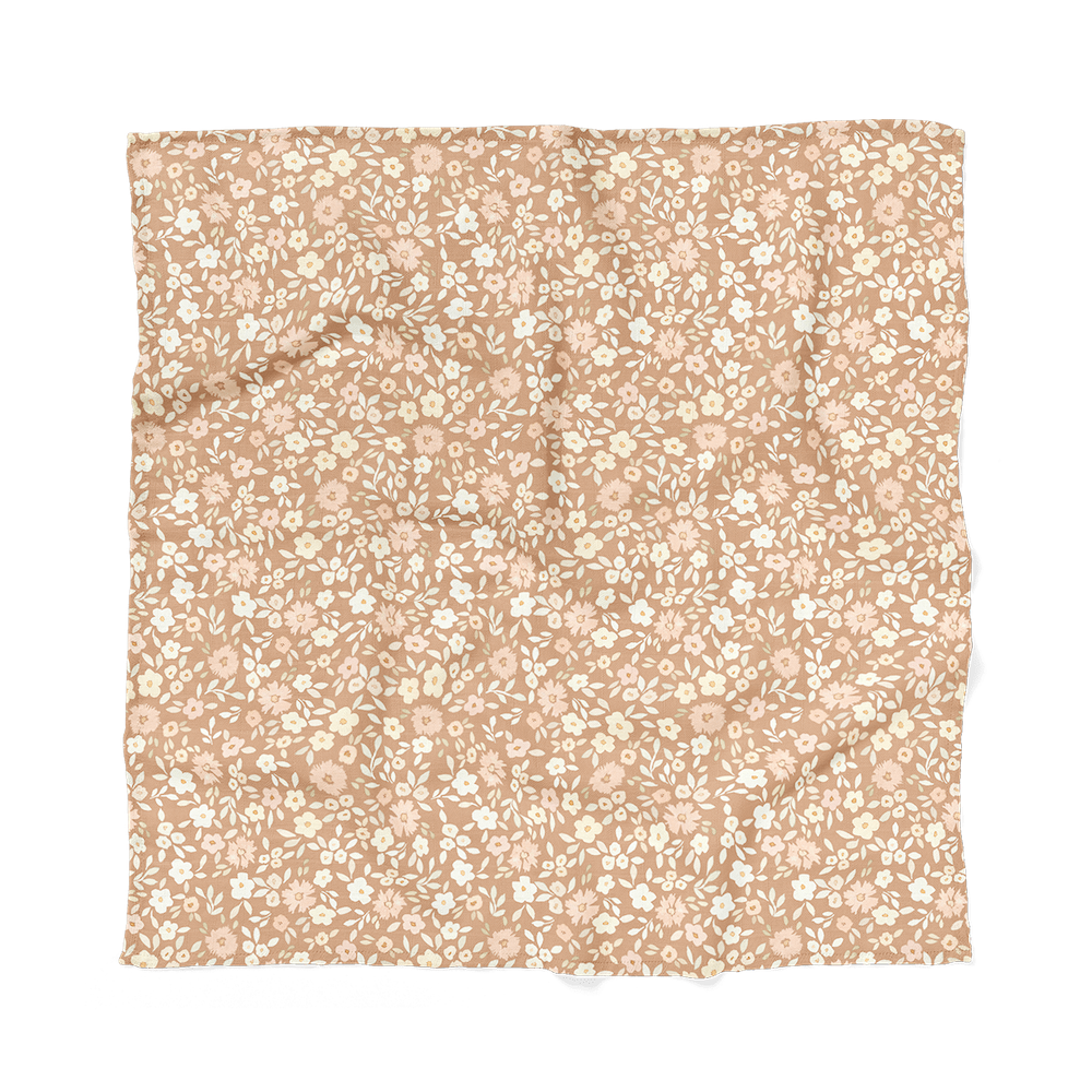 meadow swaddle laid flat showing the dainty leaves and petals creating this best baby wrap which is one of the most recommended baby essentials