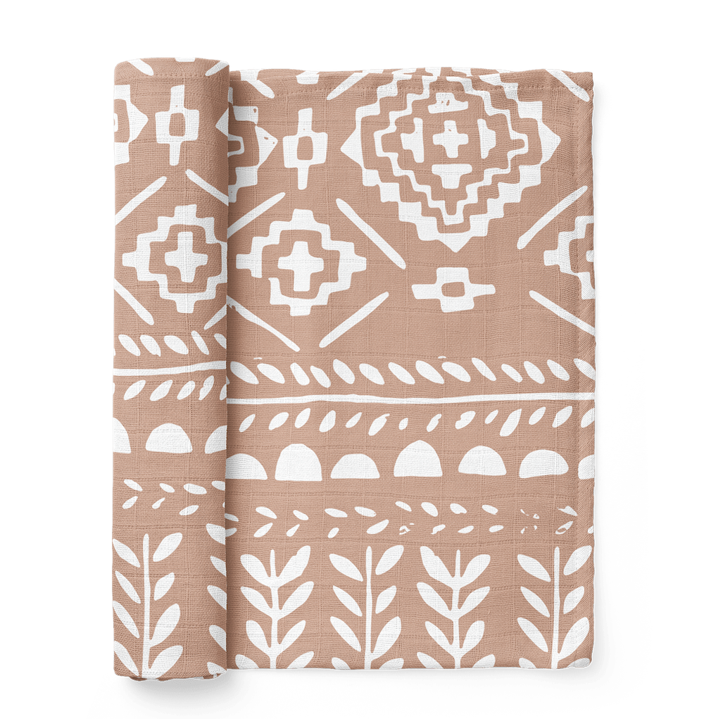 photo of our boho dusty pink swaddle which is the tapestry maple sugar muslin swaddle