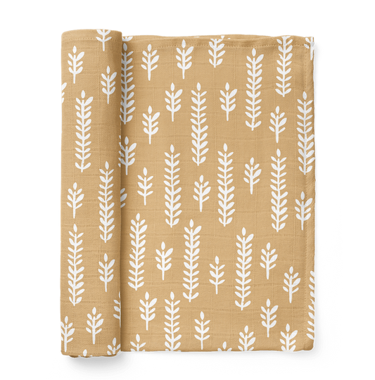 an image of a folded cream baby blanket showing the white wheat patterns