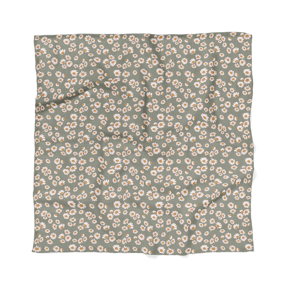 flatlay of the daisy green swaddle blanket which is part of the baby gift set for girls bundle
