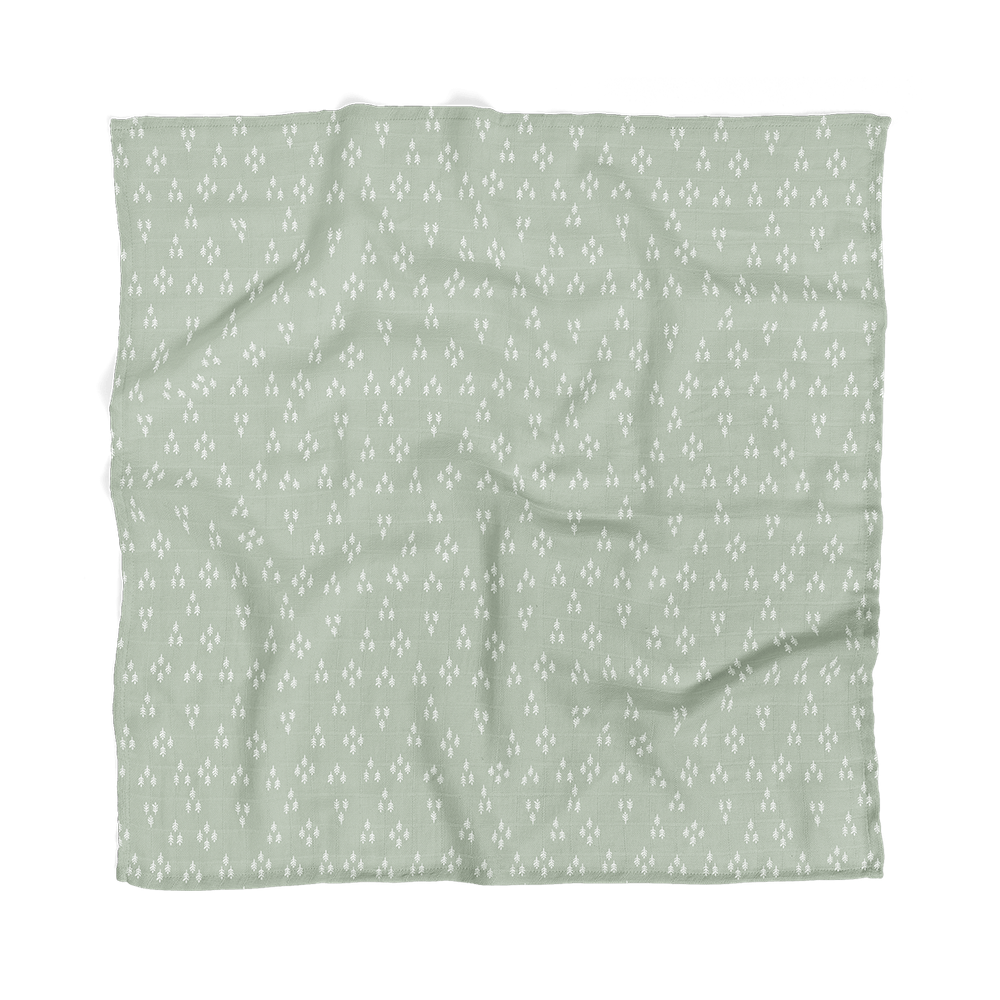 the forest baby muslin blanket laid flat showing the triangular tree patterns