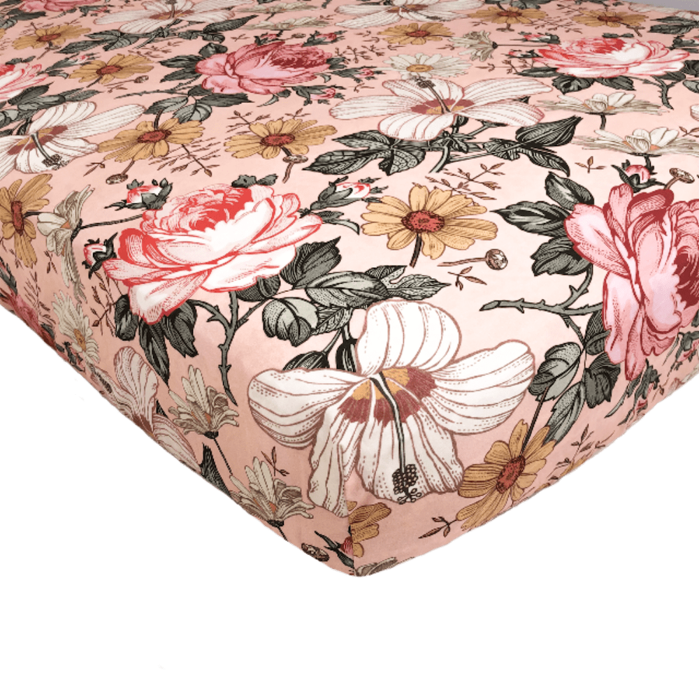 pink crib sheets with hibiscus, rose in a vibrant floral pattern features an assortment of creamy colors making it a favorite nursery decor