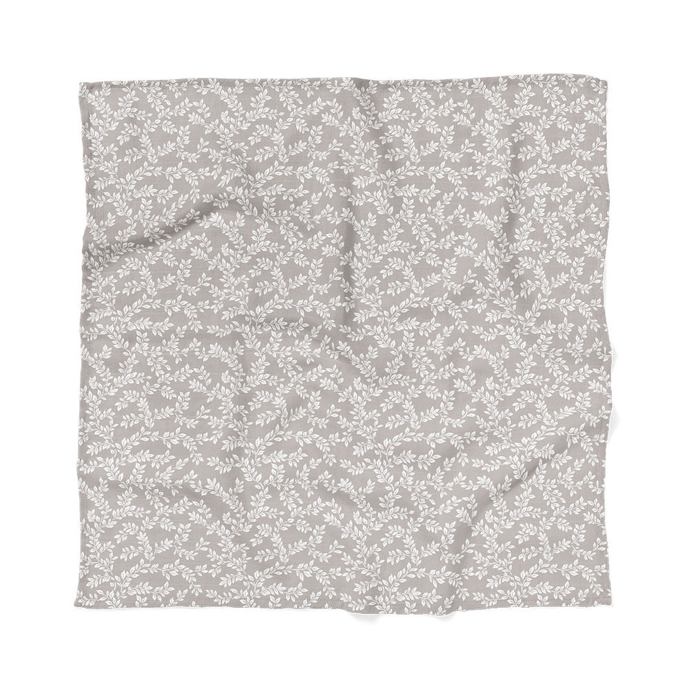 flat lay photo of the leafy sprig gray swaddle for baby boy