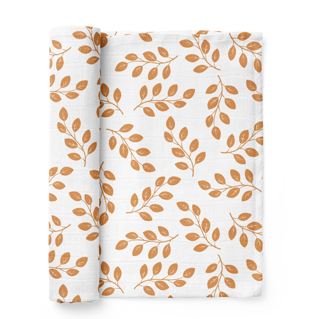half rolled leaves amber baby swaddle blanket showcasing the amber leaves design over a white background