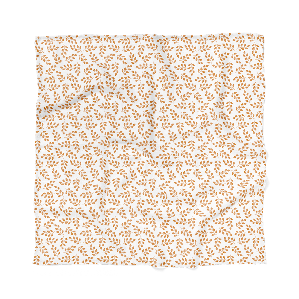 leaves amber swaddle blanket laid flat showing the amber leaves on top of the white background