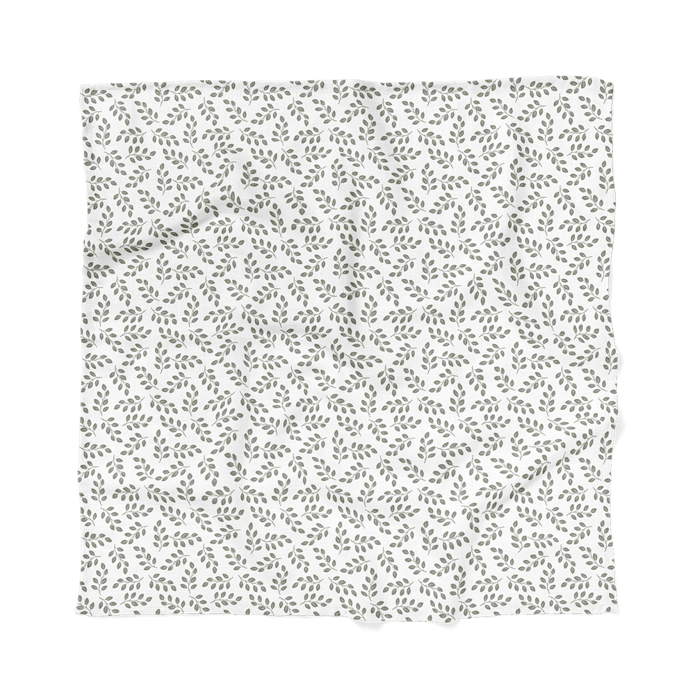 flatlay of one of the baby boy newborn set which is the leaves sage green swaddle