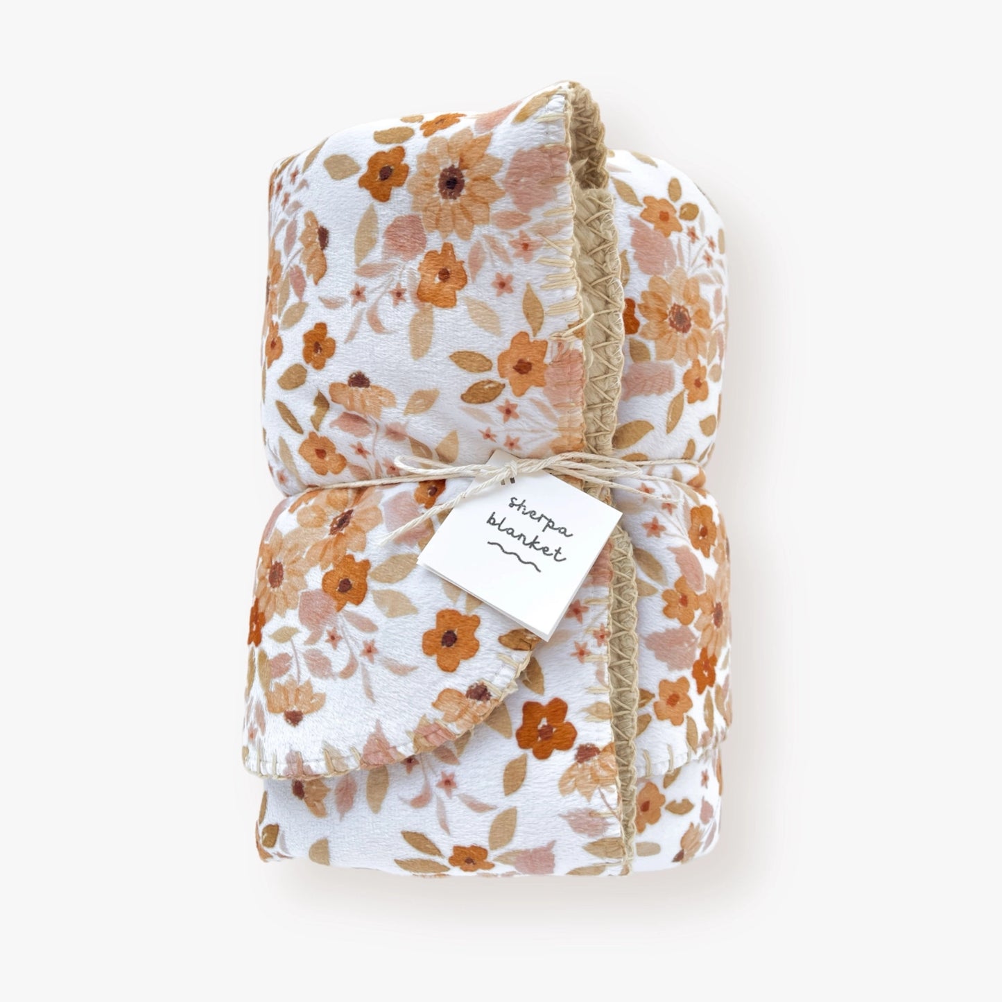 Infant sherpa blanket with sunflower patterned minky front, light brown sherpa backing, displayed.