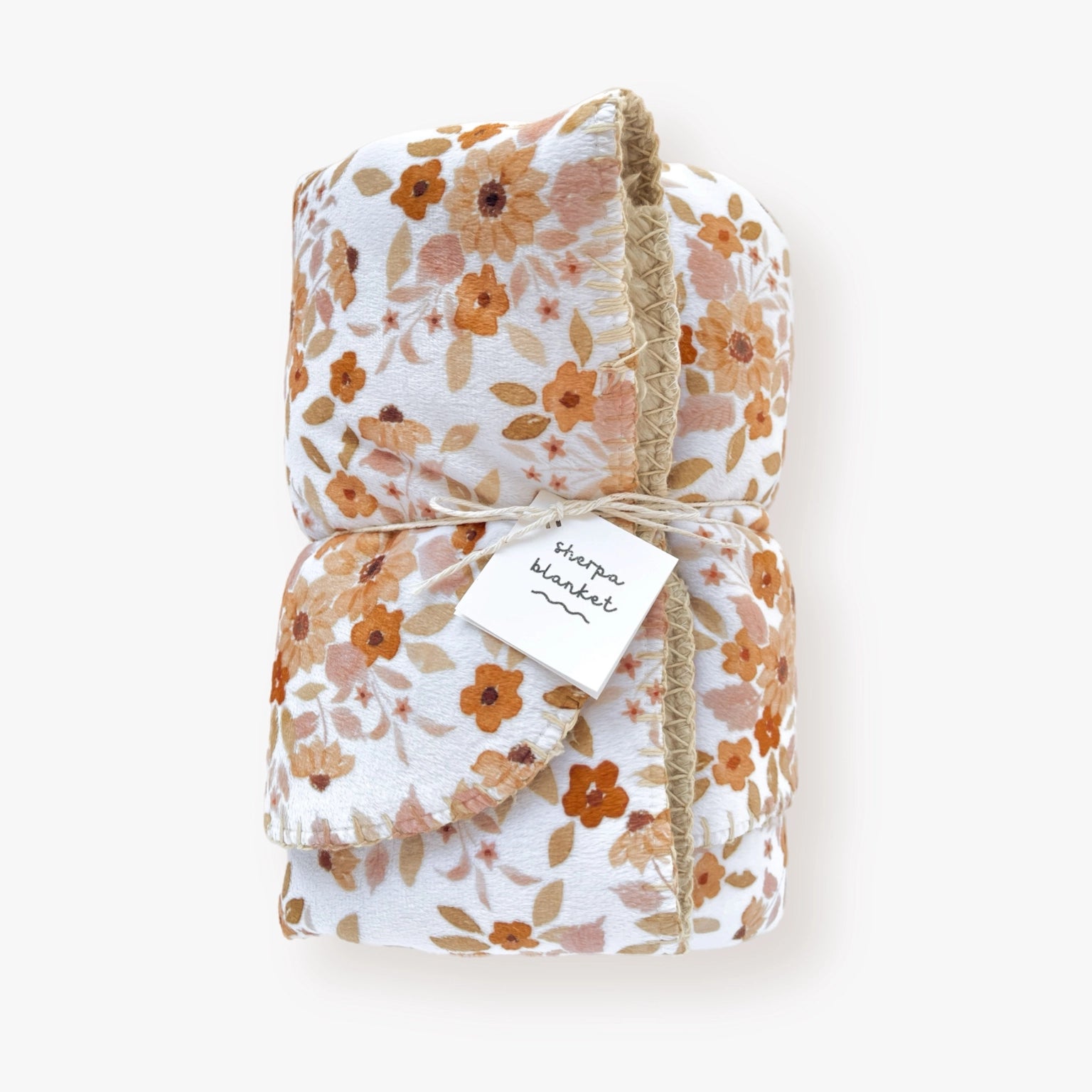 Infant sherpa blanket with sunflower patterned minky front, light brown sherpa backing, displayed.