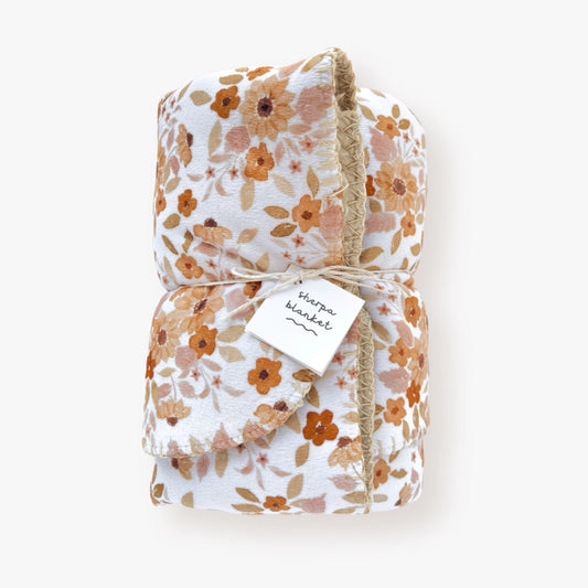 Infant sherpa blanket with sunflower patterned minky front, light brown sherpa backing, displayed.