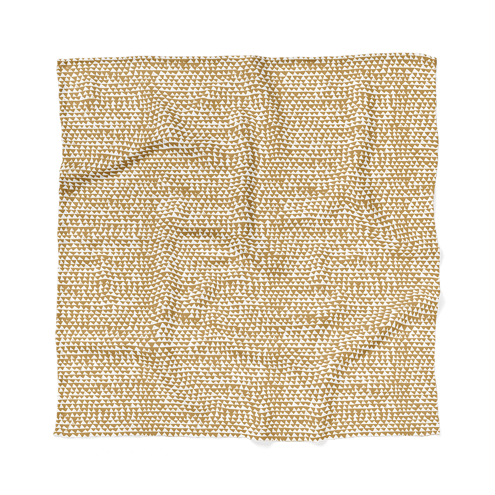mountain swaddle in honeygold laid flat to show the triangular pattern that makes it perfect for an adventure themed nursery
