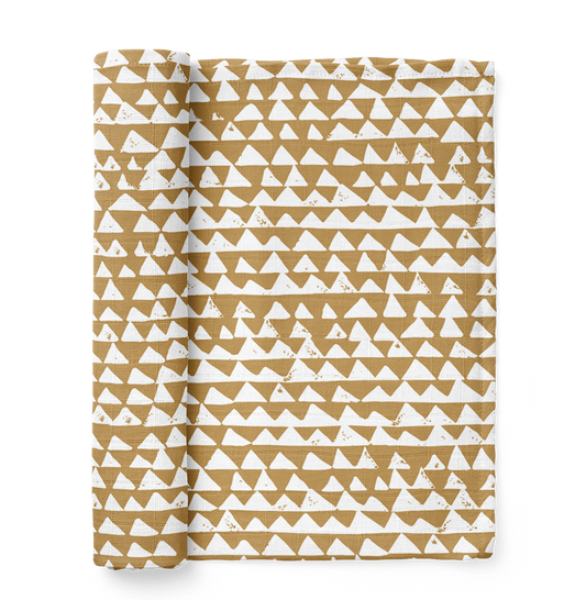 mountain swaddle in the color honey gold with a checkered triangle pattern