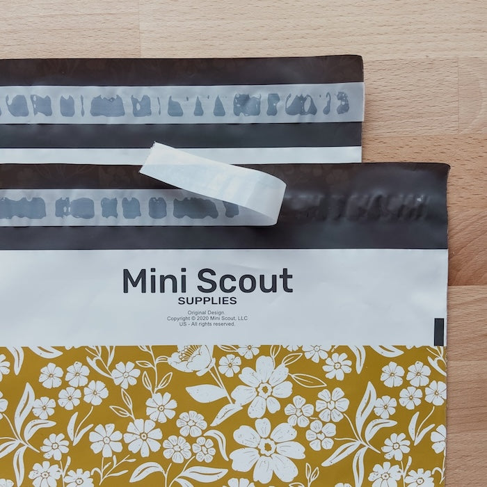 closeup photo of the yellow polymailer shipping bag also showing the peel and seal feature of the mailing bag