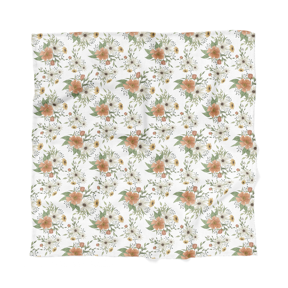 the spring blossom peony swaddle laid flat showcasing the fluffy peonies, the yellow and white daisies, leaves and more that works perfect as a boho nursery decor