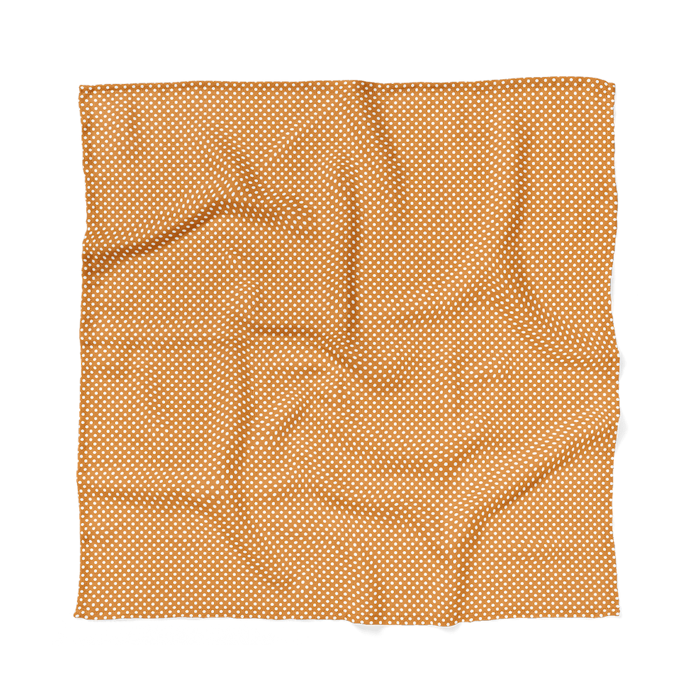 flat lay amber polka dot swaddle laid flat to highlight the entire design
