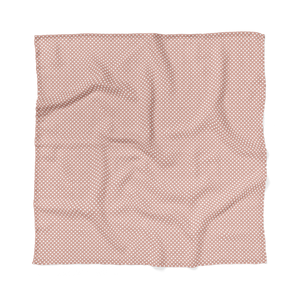 blush pink polka dot swaddle blanket laid flat