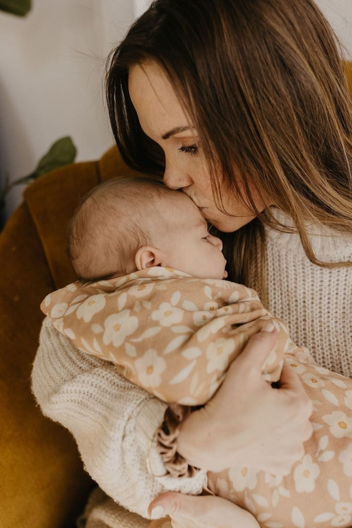 mom kissing baby wrapped in the best baby wrap