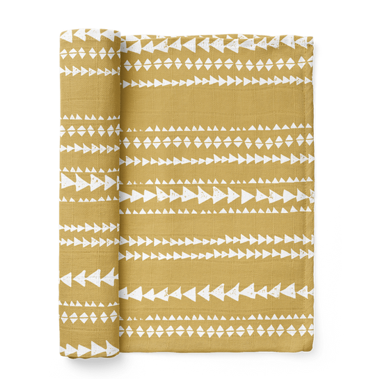 photo of the terrain muslin swaddle wrap in color mustard yellow showing the dusty yellow aztec pattern