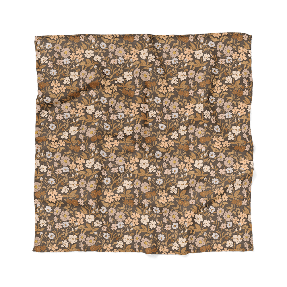 an image of the generously sized flower swaddle shown laid flat which is perfect as a nursing cover or a nursing blanket with the beautiful flowers and leaves that can match to any newborn photo outfits