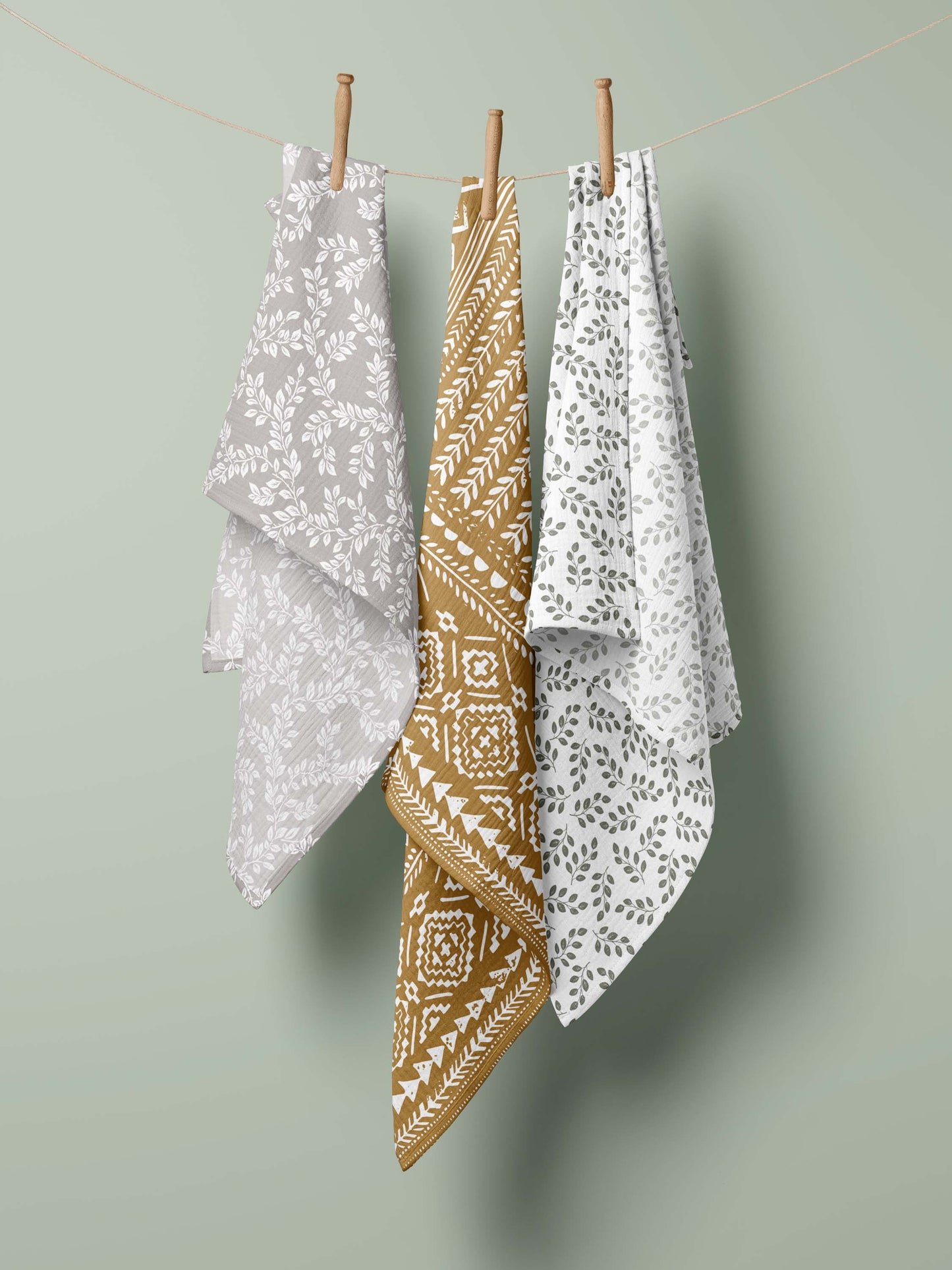 three hanging swaddle blankets in the clothesline for baby boy newborn set