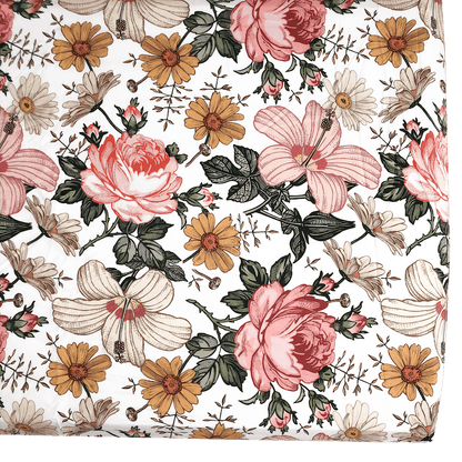 garden floral cribsheet upclose showcasing the pretty hibiscus, roses and daisies in a white background accentuating the vintage floral crib sheet look