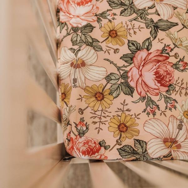 favorite nursery decor of all time the pink crib sheets focusing the hibiscus, rose and daisies in a pink background
