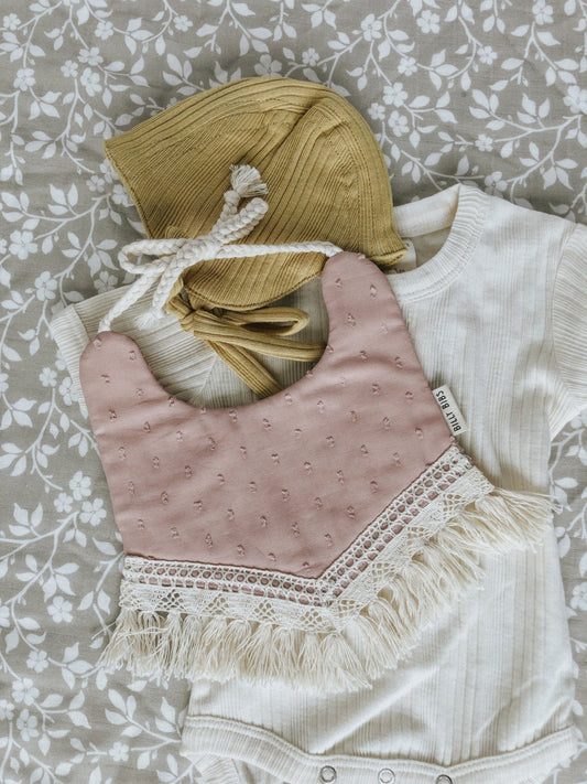 Baby Shower gift idea example with a pretty swaddle, a onesie, a bib and bonnet.