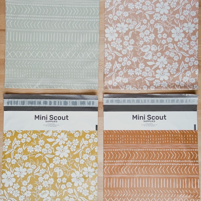 flatlay photography showing the four poly mailer shipping bags in four different colors and prints. Colors like pastel green, dusty pink, yellow and brown in floral and geometric prints