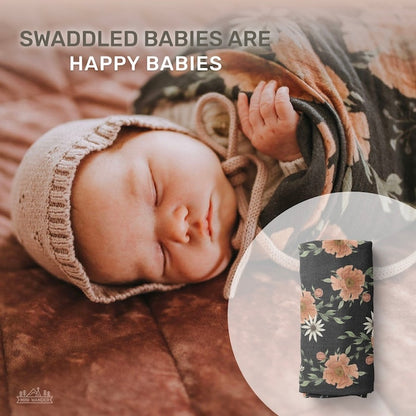 infographic that says swaddled babies are happy babies with a background showing a photo of a sleeping baby in a bonnet wrapped in the peony bloom charcoal gray swaddle