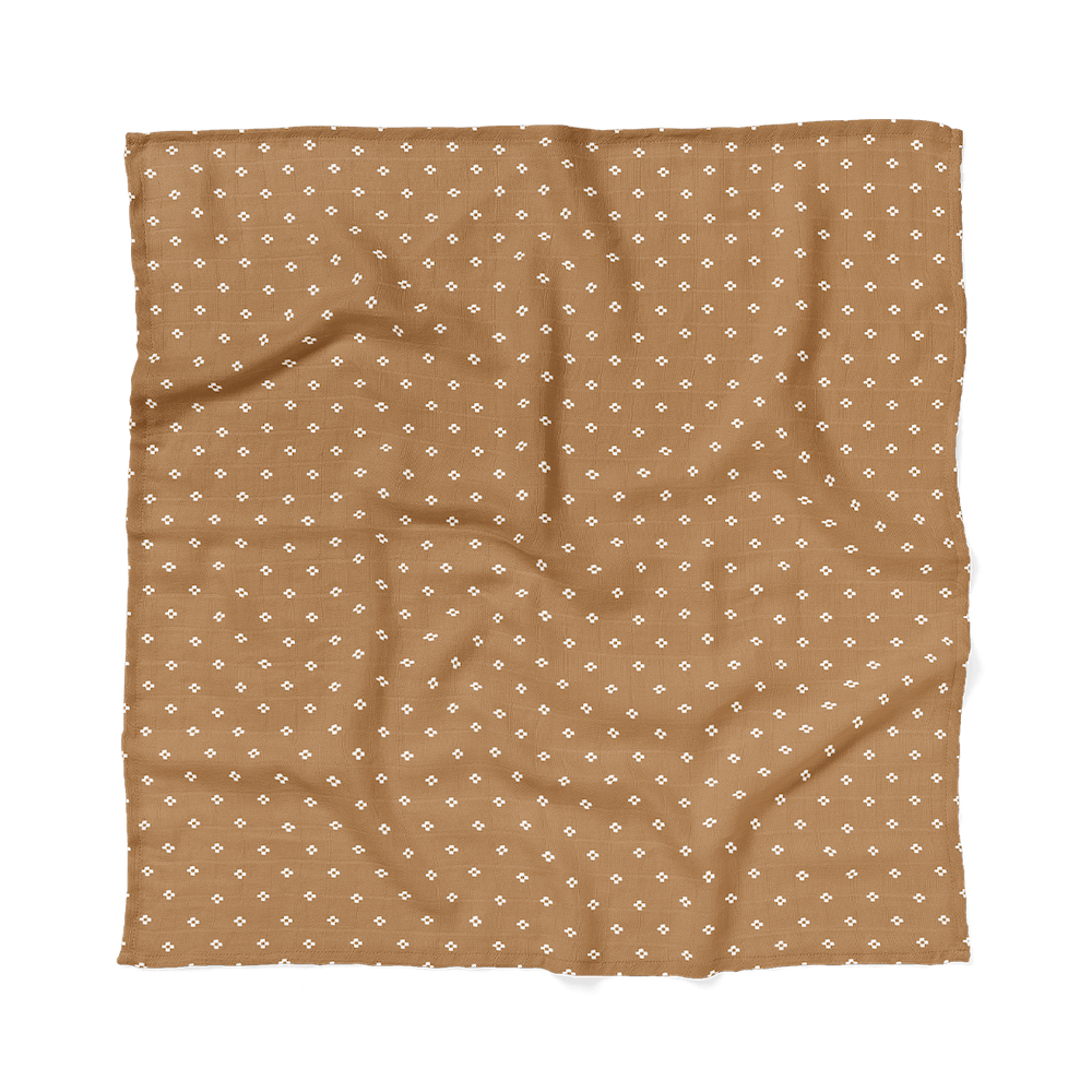 Brown boho baby blanket laid flat showing the minimalist neutral pattern