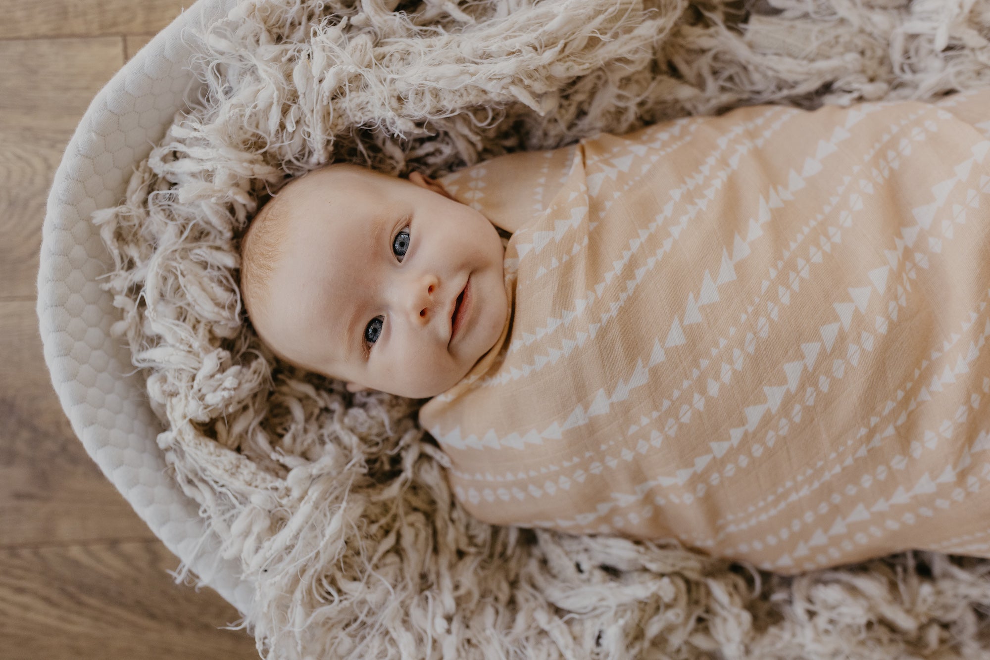 baby girl wrapped in a soft cotton blanket, milestone photoshoot