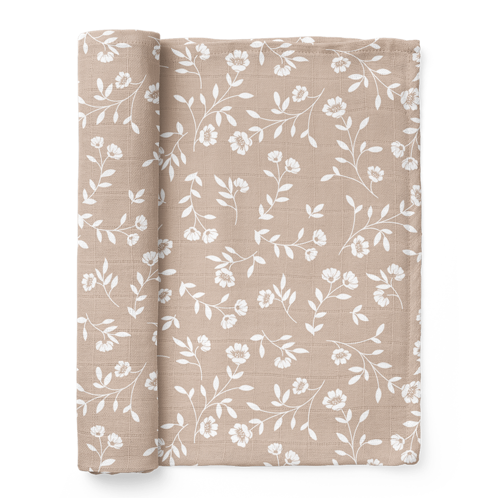 The Mini Wander wildflowers taupe floral baby blanket folded showing the wildflowers and tiny leaves