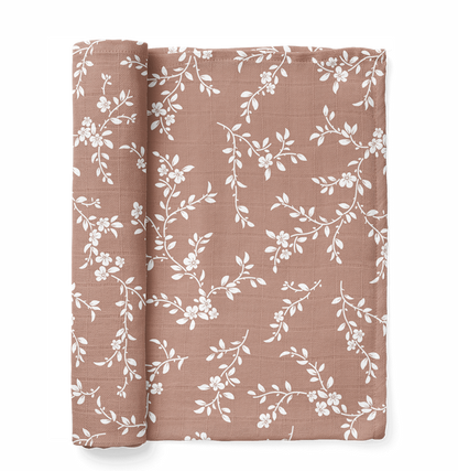 A photo of the mini wander bloom swaddle in sienna color