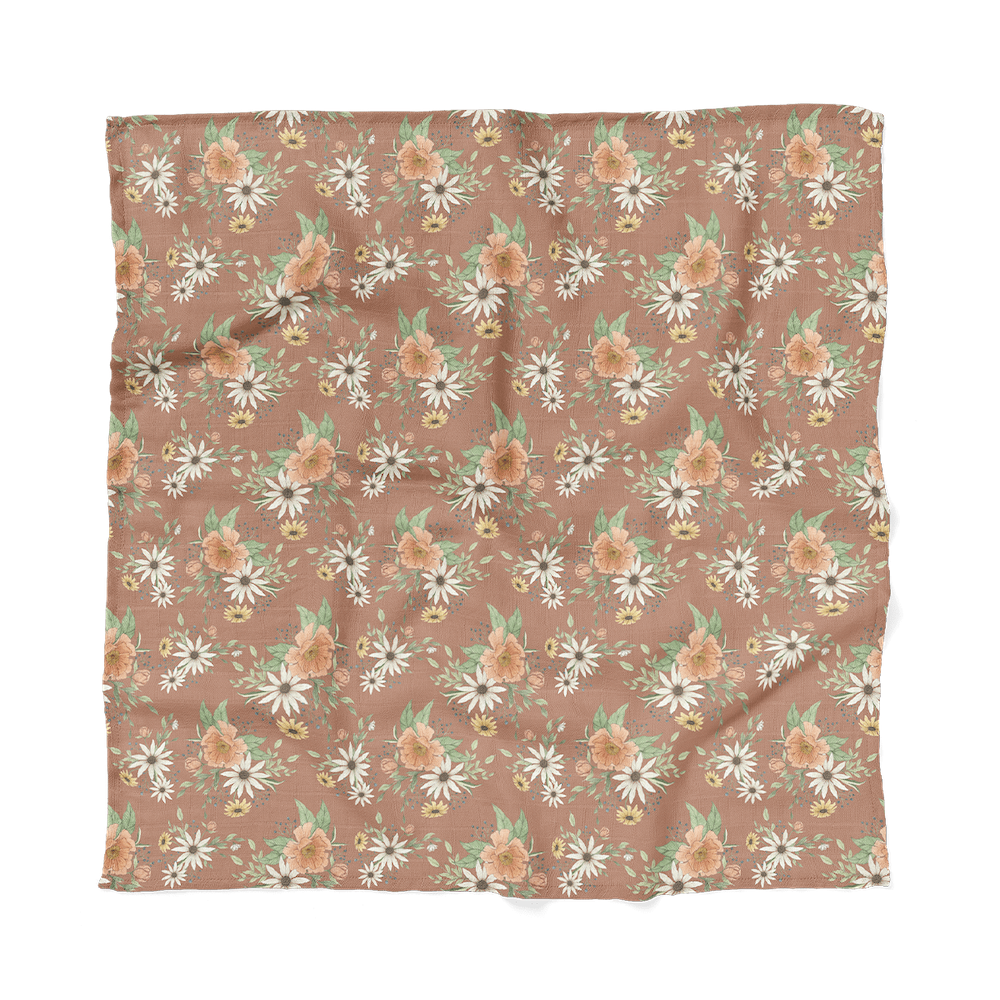 a photo of the spring blossom clay muslin baby swaddles laid flat showing the entire pattern that will look great to any boho nursery set up