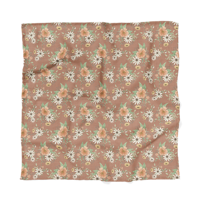 a photo of the spring blossom clay muslin baby swaddles laid flat showing the entire pattern that will look great to any boho nursery set up