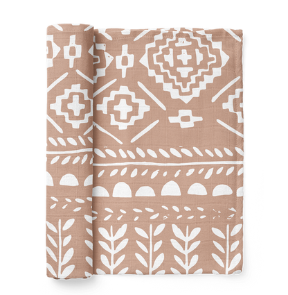 photo of our boho dusty pink swaddle which is the tapestry maple sugar muslin swaddle