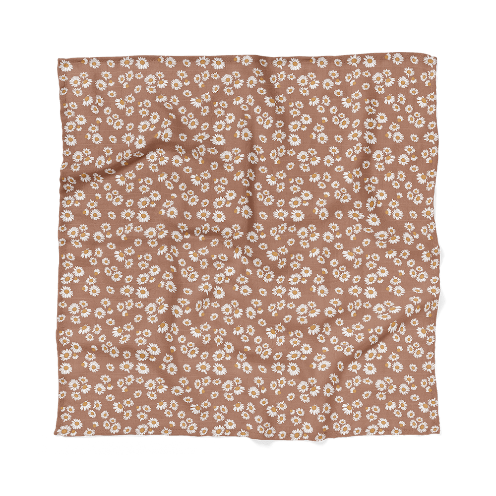 Mini Wander's view of flat earthy clay brown color with Daisy floral design swaddle.