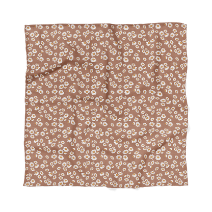 Mini Wander's view of flat earthy clay brown color with Daisy floral design swaddle.