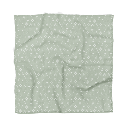 the forest baby muslin blanket laid flat showing the triangular tree patterns