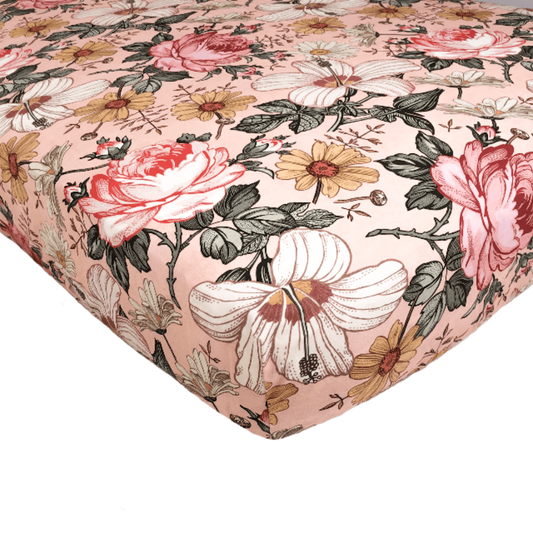 pink crib sheets with hibiscus, rose in a vibrant floral pattern features an assortment of creamy colors making it a favorite nursery decor