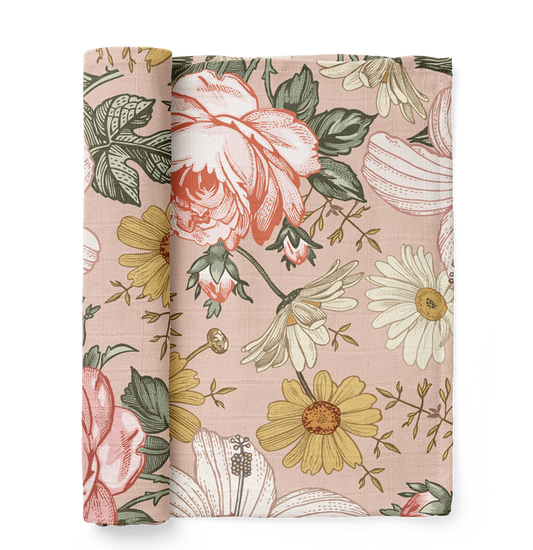 This is a rose pink baby swaddle that has a garden floral design like hibiscus, rose and daisy.
