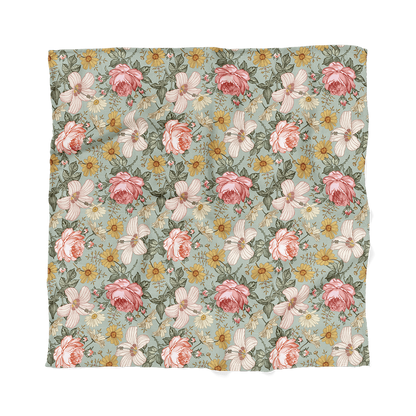 Flatlay of Mini Wander garden floral sea foam featuring daisies, roses and creamy pink hibiscus, this rich pattern adds a unique touch to your baby’s nursery.
