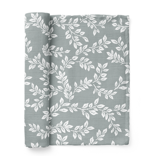 this is a mini wander leafy sprig blue swaddle. Leafy Sprig swaddle boasts an intricate design that reminisces of a sprouting twig.