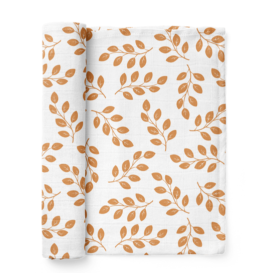 half rolled leaves amber baby swaddle blanket showcasing the amber leaves design over a white background