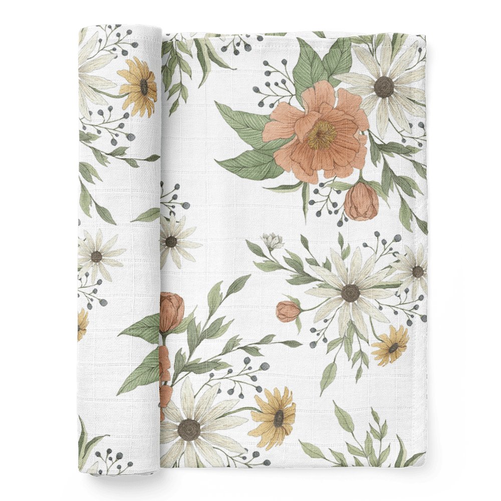 a photo of our spring blossom white peony baby swaddle folded showing the fluffy peony petals and white and yellow daisies