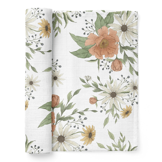 a photo of our spring blossom white peony baby swaddle folded showing the fluffy peony petals and white and yellow daisies