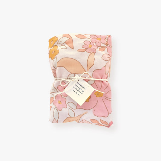 Jersey polyester cover with bold floral pattern in pink, yellow, and gray flowers, peach and pink leaves on a light pink backdrop
