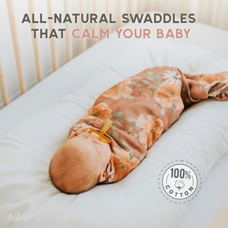 infographic sayin all natural swaddles that calm your baby with a background showing a baby wrapped in the peony blooms clay brown swaddle blanket